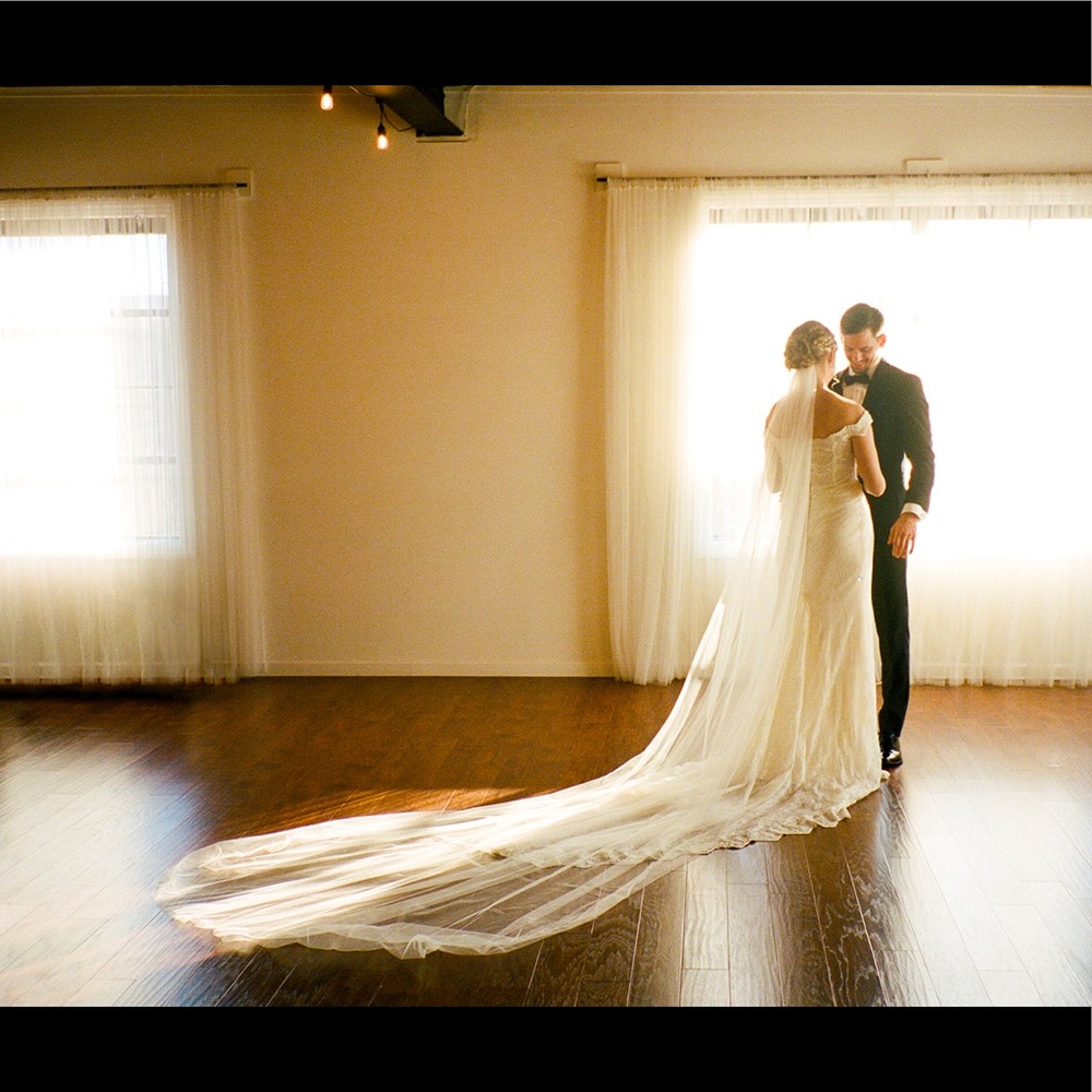 Dramatic cathedral-length, ivory raw-edge tulle veil. Perfect condition!
